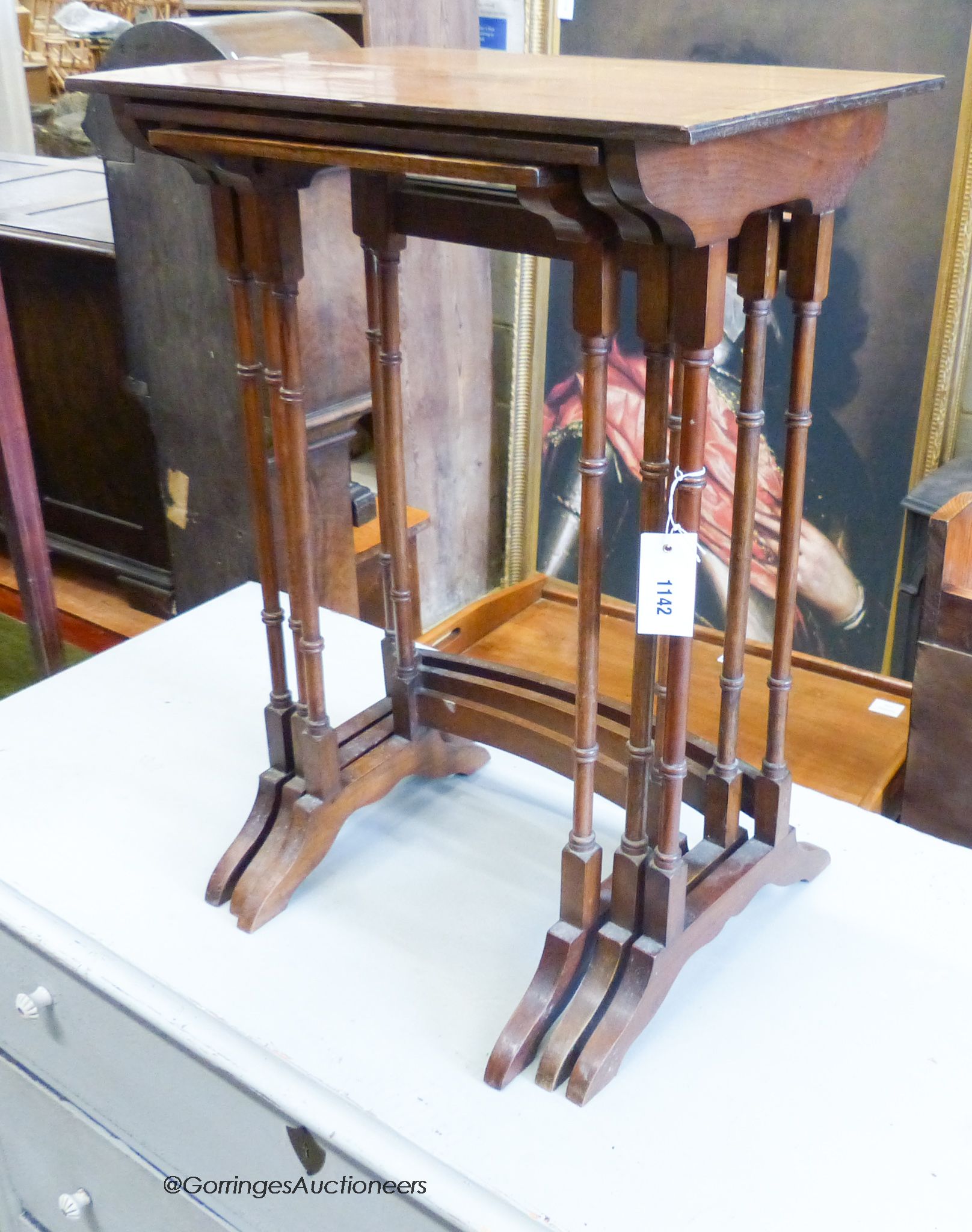 A nest of three George III Style walnut tea tables. W-49cm, D-34cm, H-67cm.